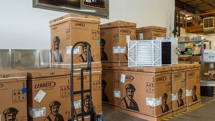 New air conditioners in boxes ready for installation.