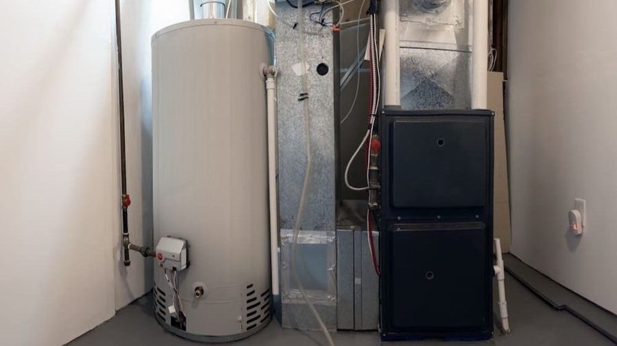 Residential furnace and water heater installed in a utility room.