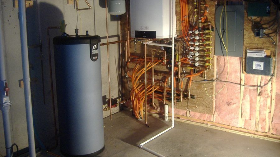 Hydronic boiler system with hot water storage tank and copper piping.